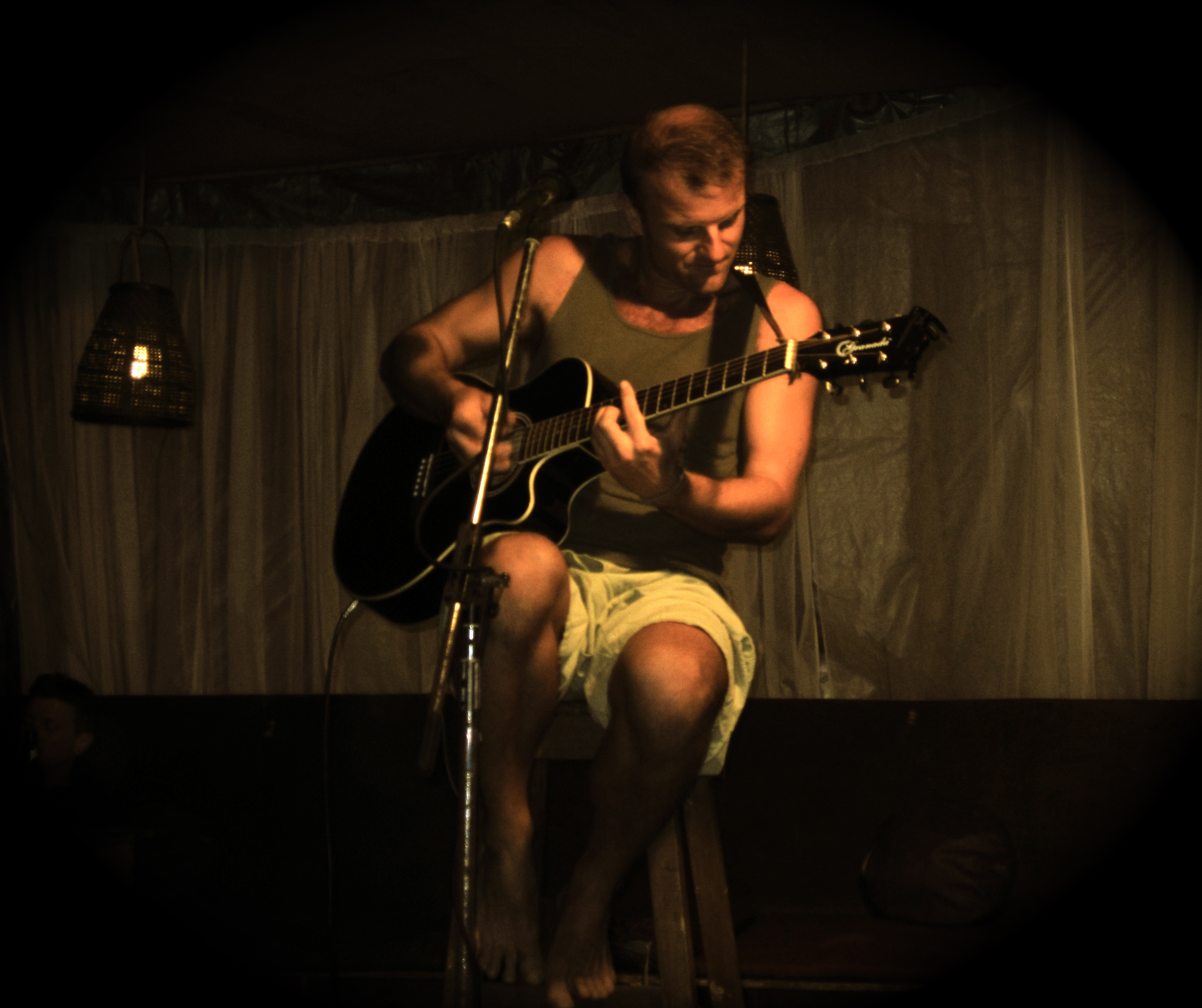 Matt playing guitar dark background